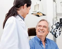 Image of a person getting their eyes tested by an optometrist